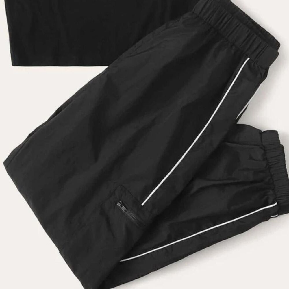 Black and white striped cargo parachute pants with scrunch at bottom